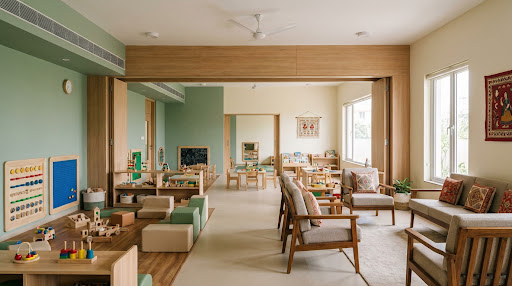 An Athini therapy room with wooden play furniture, learning boards and daylight